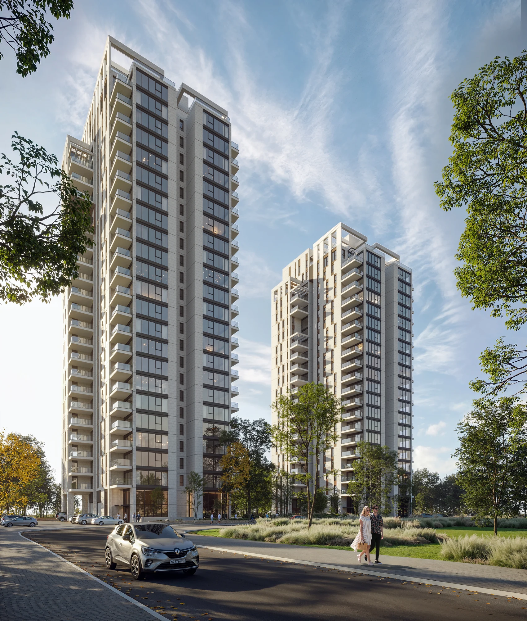 Daylight street view of two contemporary residential towers framed by trees